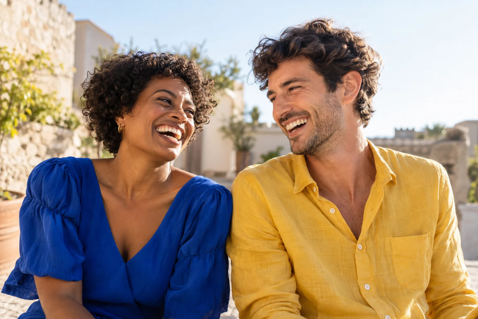 Two smiling friends laughing together outdoors
